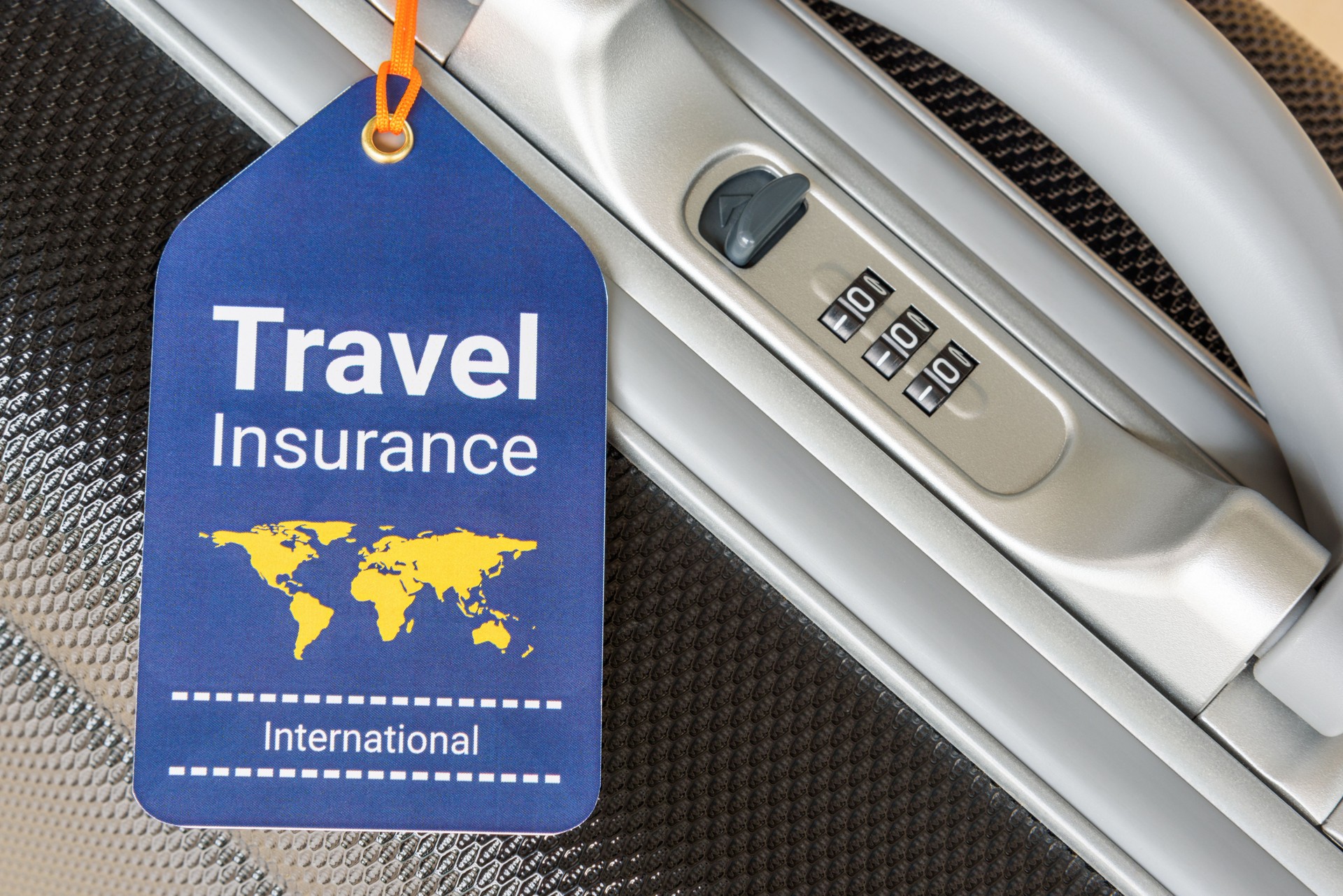 Travel safety and travel insurance concept : Travel insurance tag is hung near a numeric combination lock.